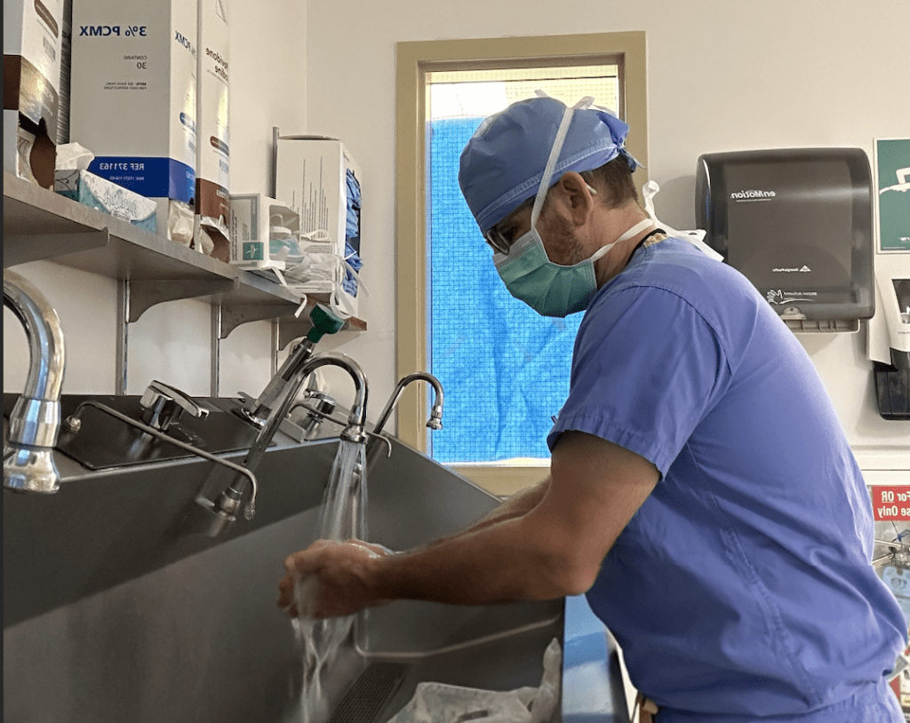 Photo of a surgeon scrubbing in for a surgical case