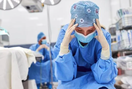 Photo of a surgeon that appears stressed and frustrated